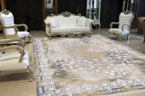Grey and gold acrylic carpet in front of a white classic sofa and armchairs